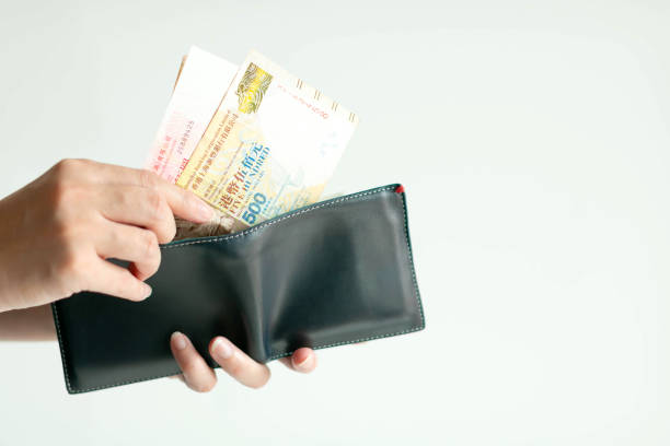 istock Hands picking Hong Kong money (Dollar Hong Kong or HKD) from wallet for paying. 1164392635