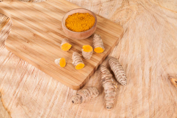 istock Turmeric powder and fresh turmeric on wooden background (Curcuma longa) 1164392802