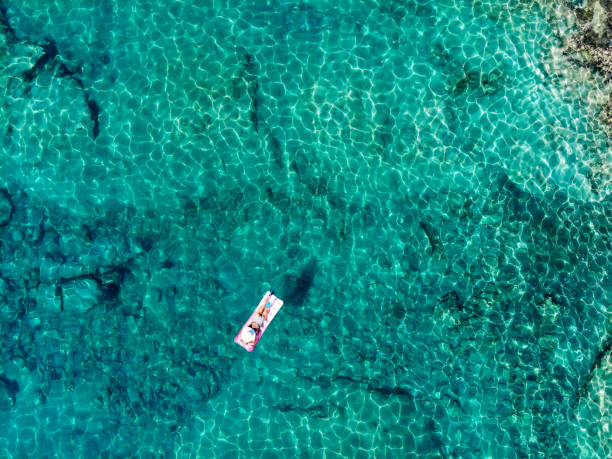 istock Drone image of woman on seabed. 1164392973
