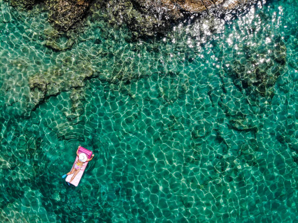 istock Drone image of woman on seabed. 1164393849