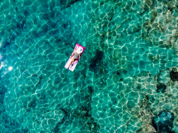 istock Drone image of woman on seabed. 1164397293