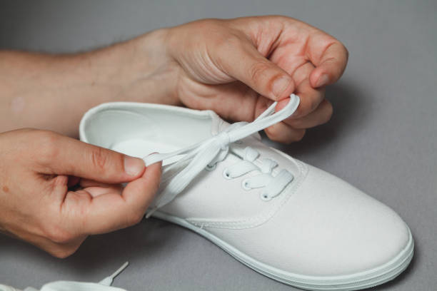 istock Hands tie  lace on new white sneaker 1164398464