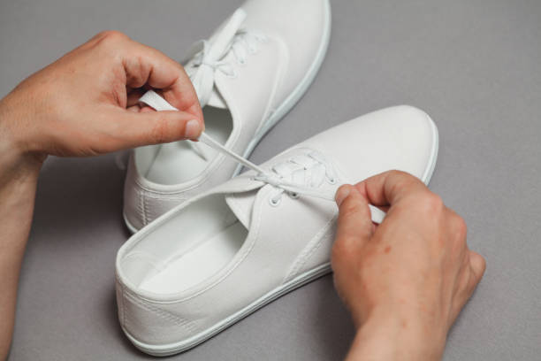 istock Hands tie  lace on new white sneaker 1164398763
