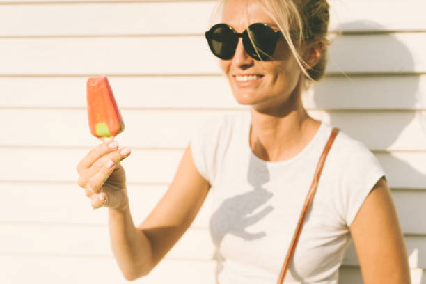 istock girl with popsicle in sunglasses is laughing 1164399645