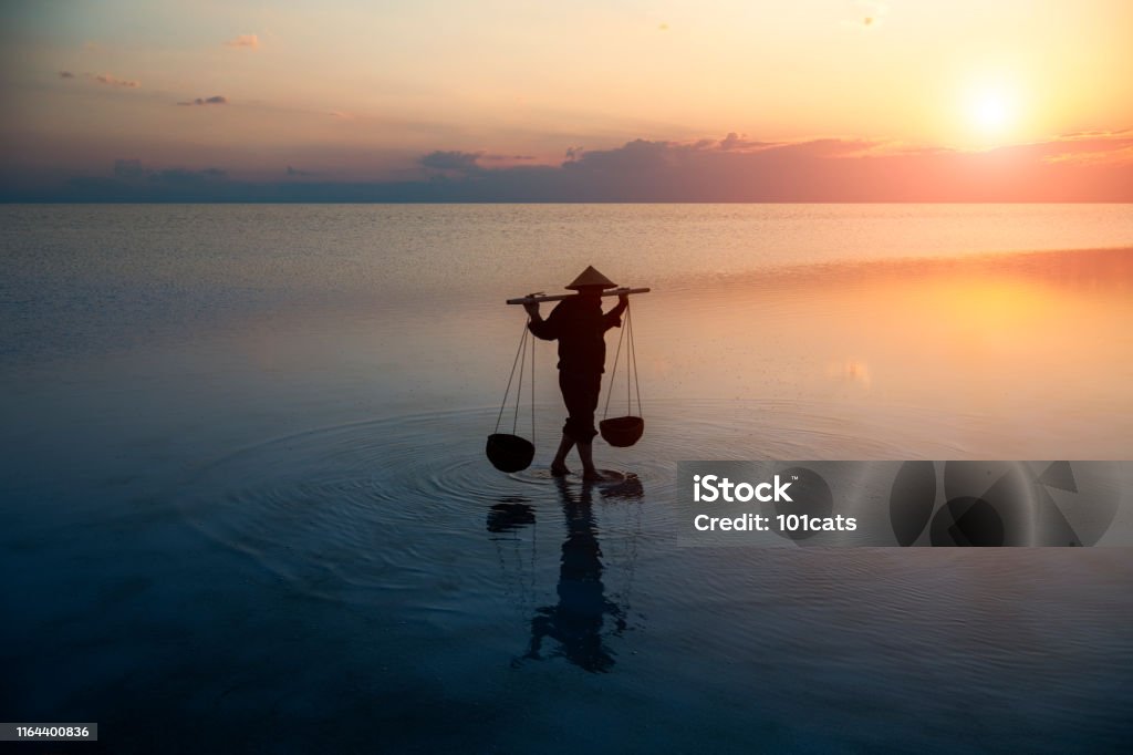 Farmer carrying baskets on the water. Japan Stock Photo