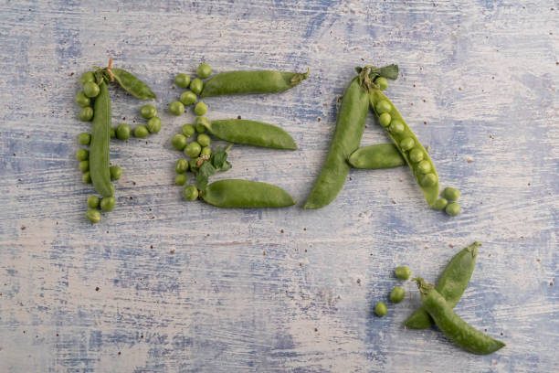 fresh raw peas on a wooden table