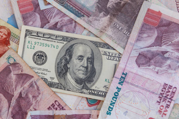 istock One hundred dollar bill on the egyptian pounds banknotes background 1164404737