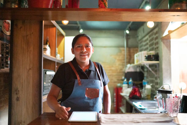 istock Portrait of waitress using digital tablet and looking at camera 1164404988