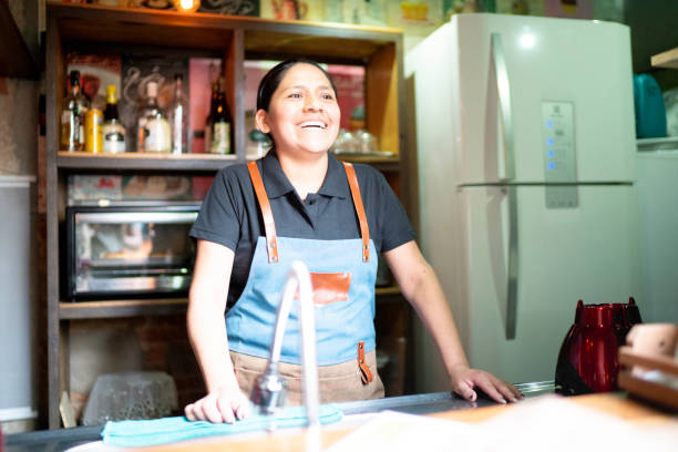 istock Smiling waitress looking at the restaurant 1164405212