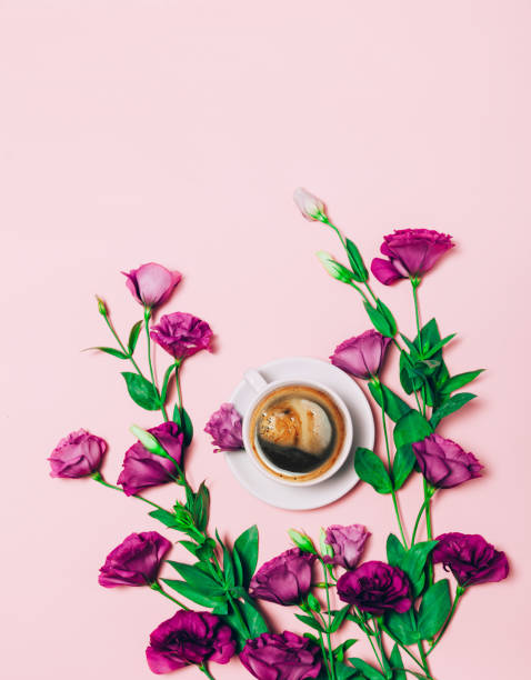 istock Cup of coffee abd beautiful flowers on pink background. 1164406543