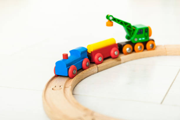 istock Child'd wooden train on the white floor 1164412380