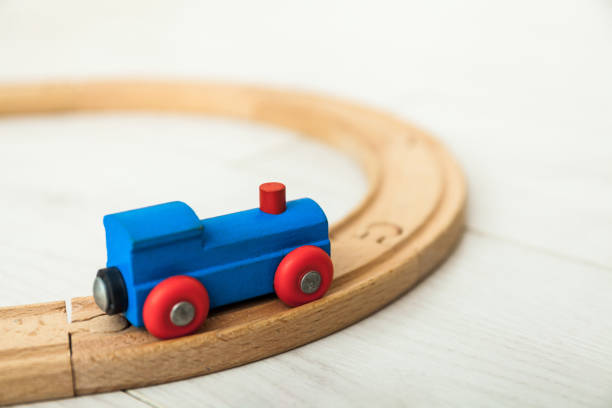 istock Child's wooden train on the white floor 1164412419