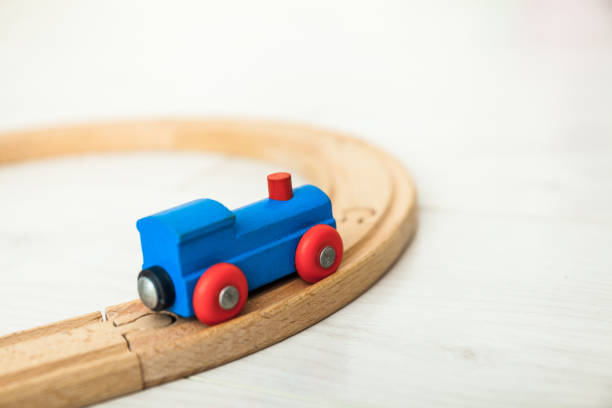 istock Child'd wooden train on the white floor 1164412425