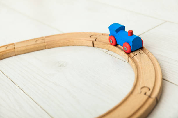 istock Child'd wooden train on the white floor 1164412437