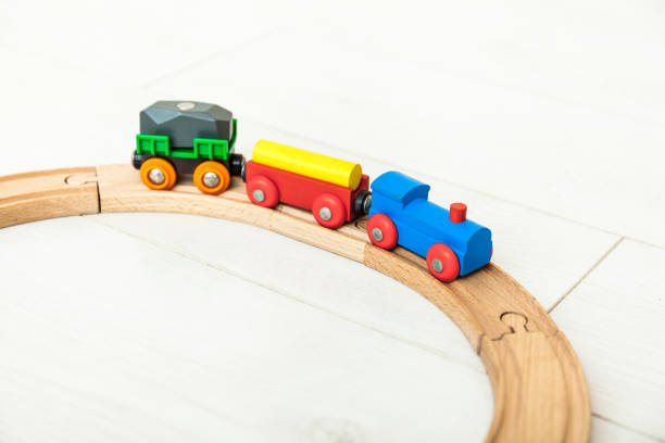 istock Child'd wooden train on the white floor 1164412470