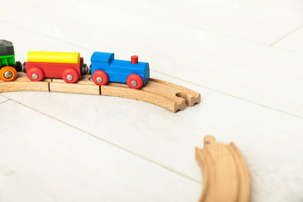 istock Child's wooden train on the white floor 1164412515