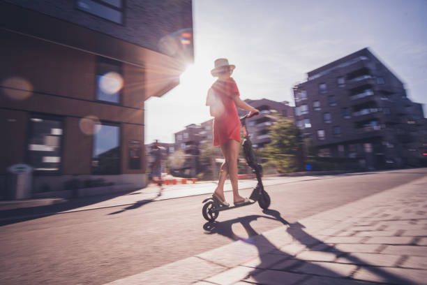 istock Young woman on electric scooter. 1164414862