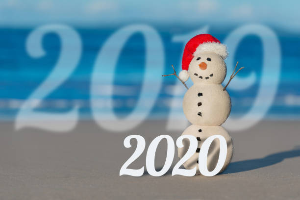 istock Christmas Sandy Snowman on a beautiful sand beach 1164421269