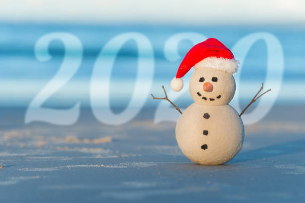istock Christmas Sandy Snowman on a beautiful sand beach 1164421310