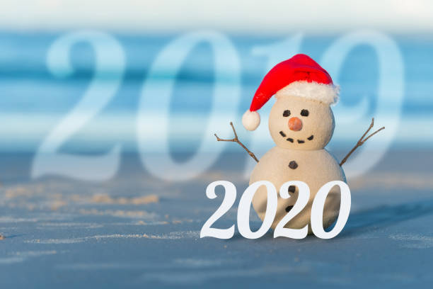 istock Christmas Sandy Snowman on a beautiful sand beach 1164421313