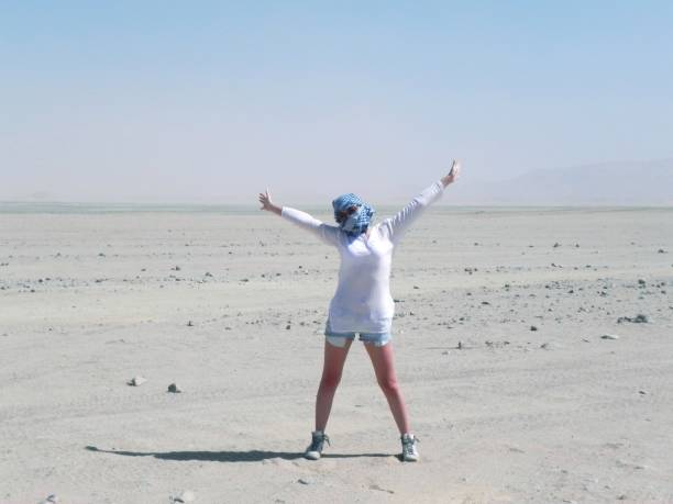 istock Girl in Sahara desert 1164421562