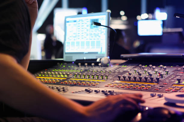 visual and audio mixers for montage and production at live events close ups on sound engineer with studio sound and visual mixer used for media and events directing and recording studios broadcast programming photos stock pictures, royalty-free photos & images