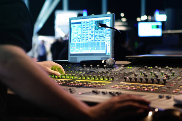 visual and audio mixers for montage and production at live events close ups on sound engineer with studio sound and visual mixer used for media and events directing and recording studios soundtrack stock pictures, royalty-free photos & images