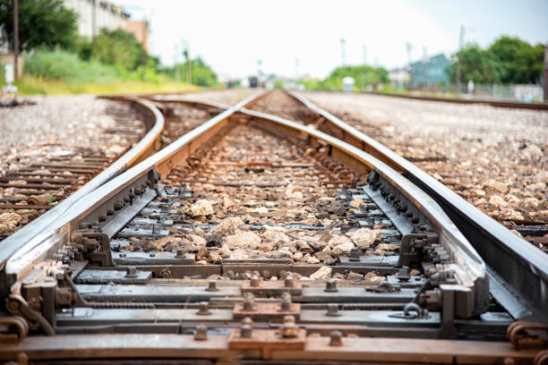 Railroad Track Switch Detail The switch, or intersection, of two railroad tracks located in the urban downtown Houston area. railway track stock pictures, royalty-free photos & images