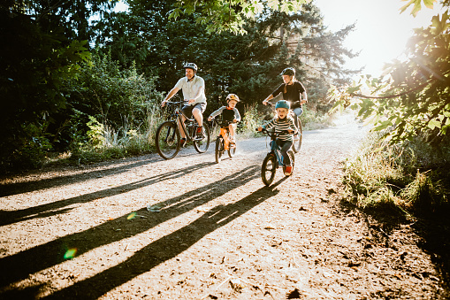 Family Mountain Bike Riding Together on Sunny Day photo