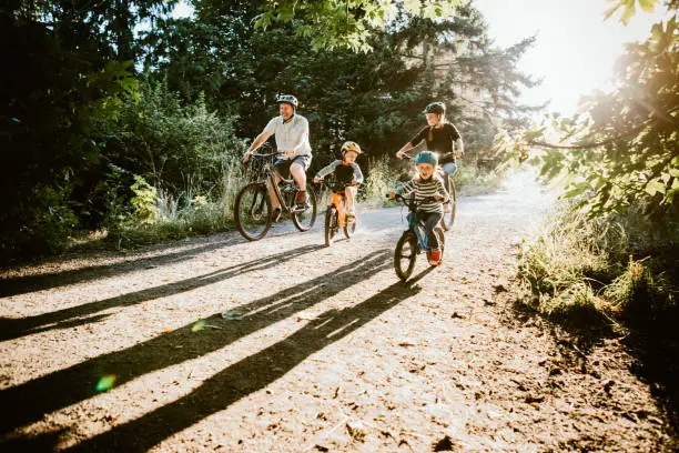 Photo of Family Mountain Bike Riding Together on Sunny Day
