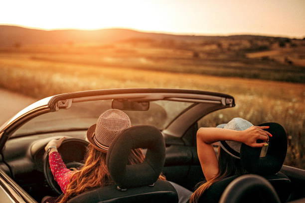 istock Girls enjoying ride in convertible 1164432054