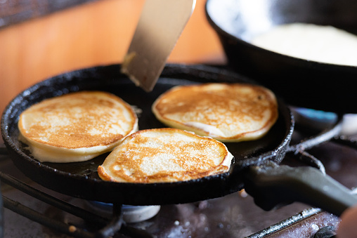 Homemade pancakes for breakfast in a cast iron pan.