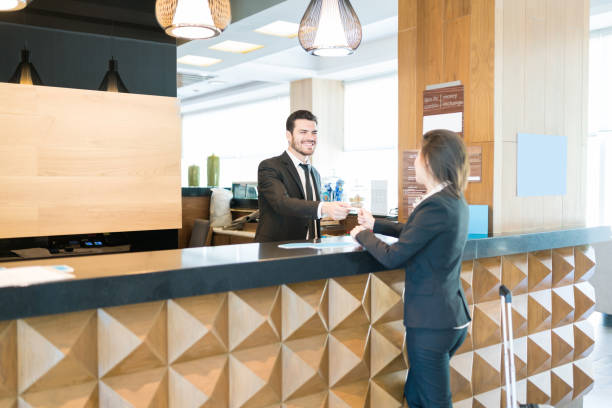 istock Entrepreneur Taking Access Key From Clerk At Reception Counter 1164435143