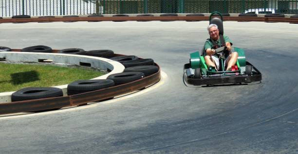 istock senior man driving go-cart 1164439583