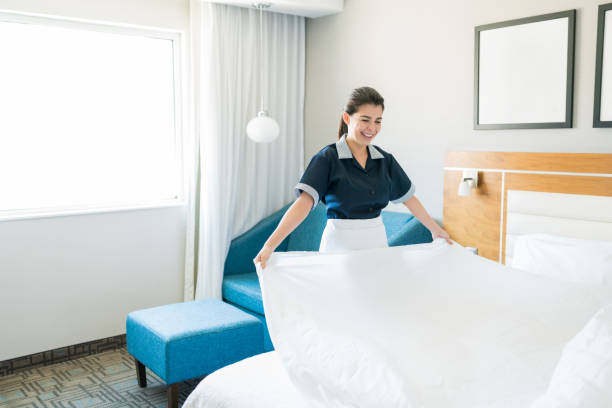 istock Mid Adult Hotel Maid Changing Bed Sheets 1164445557