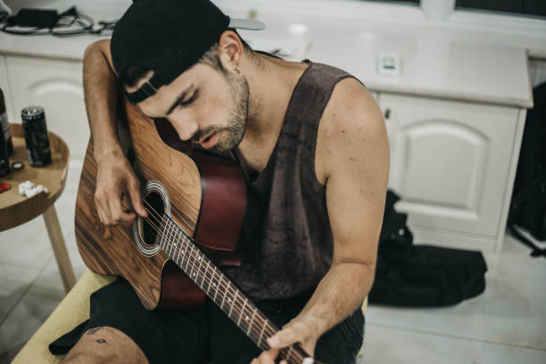 istock Man with Acoustic Guitar Writing Songs 1164451050