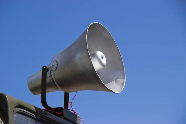 istock vintage, aluminum  loudspeaker on clear sky background. 1164451134