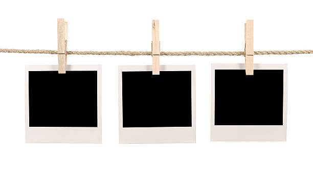 istock Three blank instant retro photos clipped on a washing line 116445593