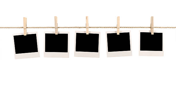Blank instant photo prints on a washing line Several blank instant photo prints hanging on a rope or washing line.  If you’d like to see my complete collection of blank Polaroids please  CLICK HERE.   Alternative version of this file shown below: clothespin photos stock pictures, royalty-free photos & images