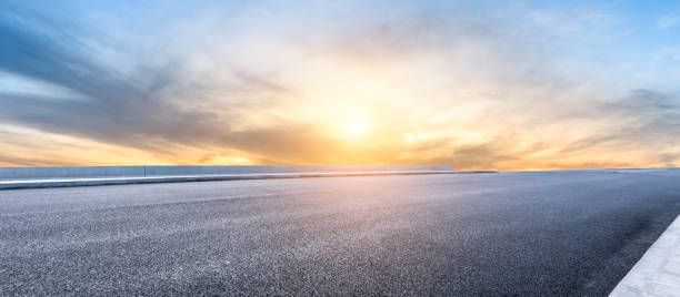 istock Asphalt highway and beautiful clouds landscape at sunset 1164460192