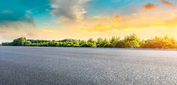istock Asphalt highway and green forest with beautiful clouds landscape at sunset 1164460465
