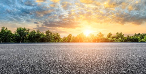 istock Asphalt highway and green forest with beautiful clouds landscape at sunset 1164461047