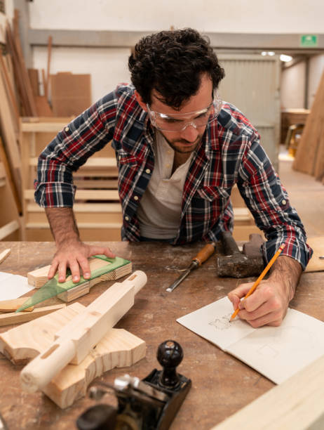 istock Carpenter sketching a design at his wood workshop 1164461131