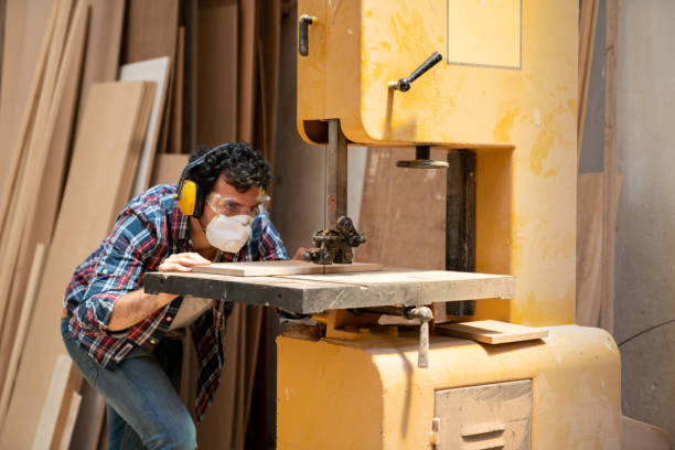 istock Man at a carpentry cutting wood using a jigsaw 1164461174