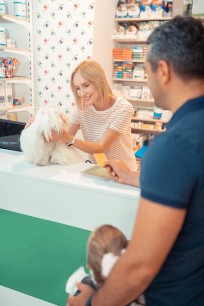 istock Man paying for dog by card while buying it for daughter 1164461521