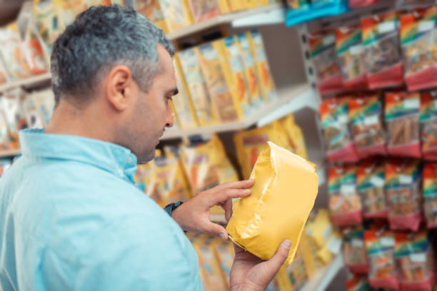 istock Man reading description choosing food for cat 1164461533
