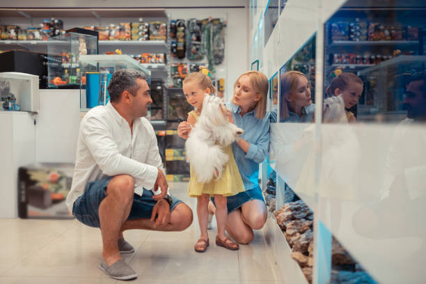 istock Daughter with fluffy dog visiting aquarium with mom and dad 1164461620