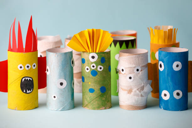 istock Halloween crafts, paper ghost, monsters on blue paper background with copy space for text. halloween concept handcraft, diy, creative idea from toilet tube, recycle 1164462379