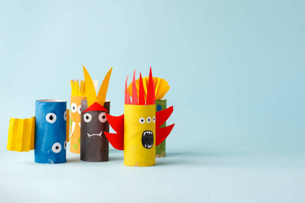 istock Halloween crafts, paper ghost, monsters on blue paper background with copy space for text. halloween concept handcraft, diy, creative idea from toilet tube, recycle 1164462383