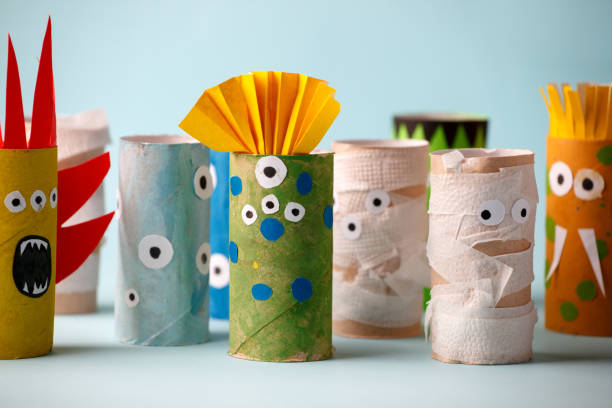 istock Halloween crafts, paper ghost, monsters on blue paper background with copy space for text. halloween concept handcraft, diy, creative idea from toilet tube, recycle 1164462387
